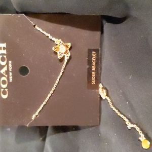 Matching Coach star earrings and slider bracelet